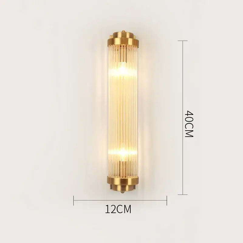 Modern gold crystal wall lamp with brushed gold frame and vertical glass rods emitting warm light for living room use