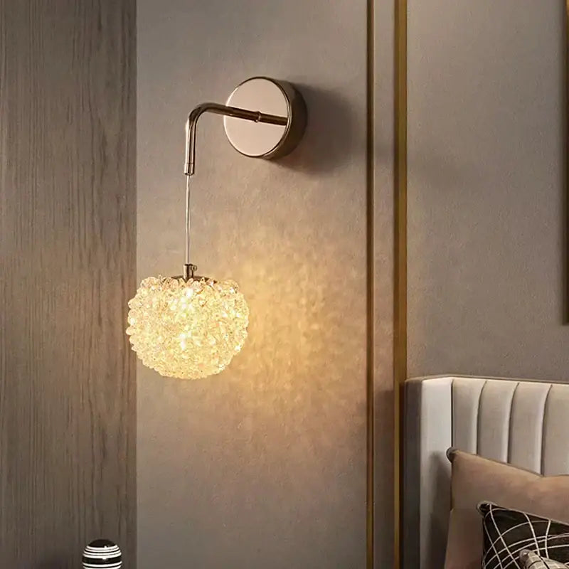 Modern gold crystal wall lights sconce featuring a warm glowing brass arm with a delicate crystal-encrusted globe for bedroom decorbites crystal wall use
