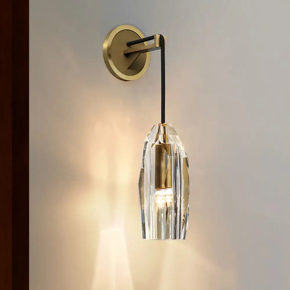 Modern gold crystal wall sconce with faceted glass shade and gold-toned metal base direct wired electric light