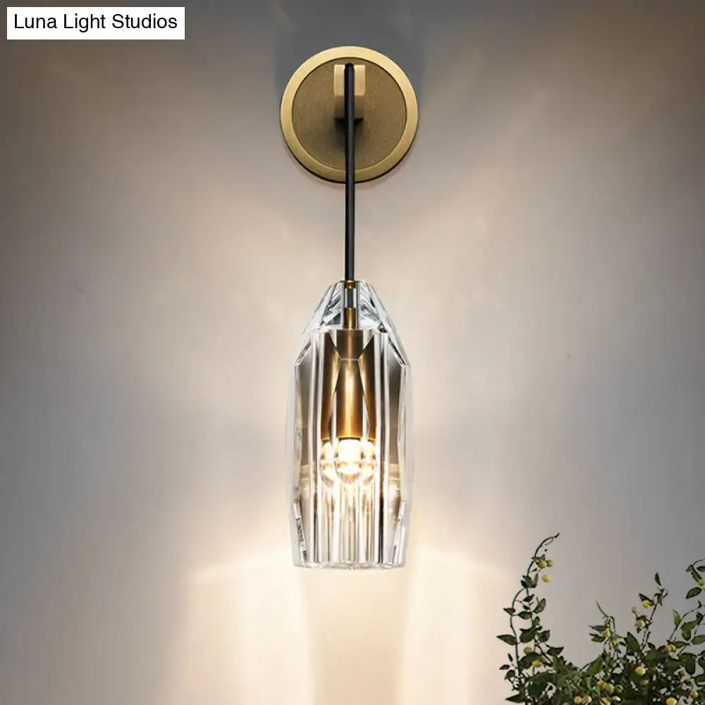 A modern gold crystal wall sconce with faceted clear glass and brass accents direct wired electric light fixture