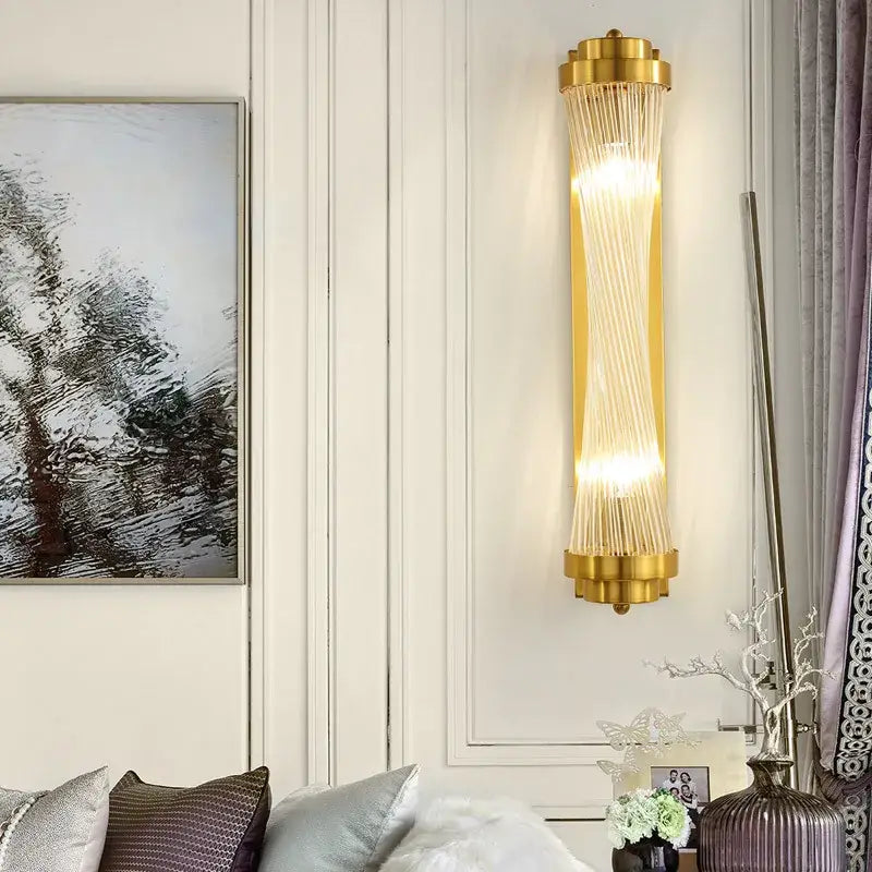 Modern gold crystal wall sconce with cylindrical glass rods emitting warm light for bedroom decorbites crystal wall use
