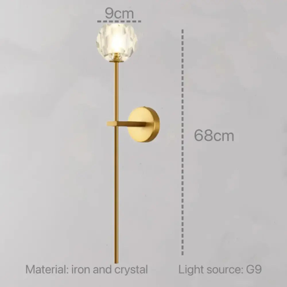 Modern gold decorbites crystal wall sconce with faceted crystal globe and slender iron stem for bedroom led lighting