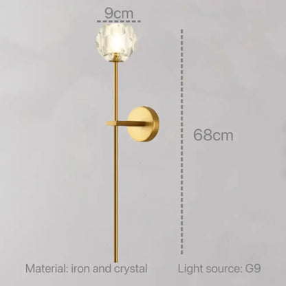 Modern gold decorbites crystal wall sconce with faceted crystal globe and slender iron stem for bedroom led lighting