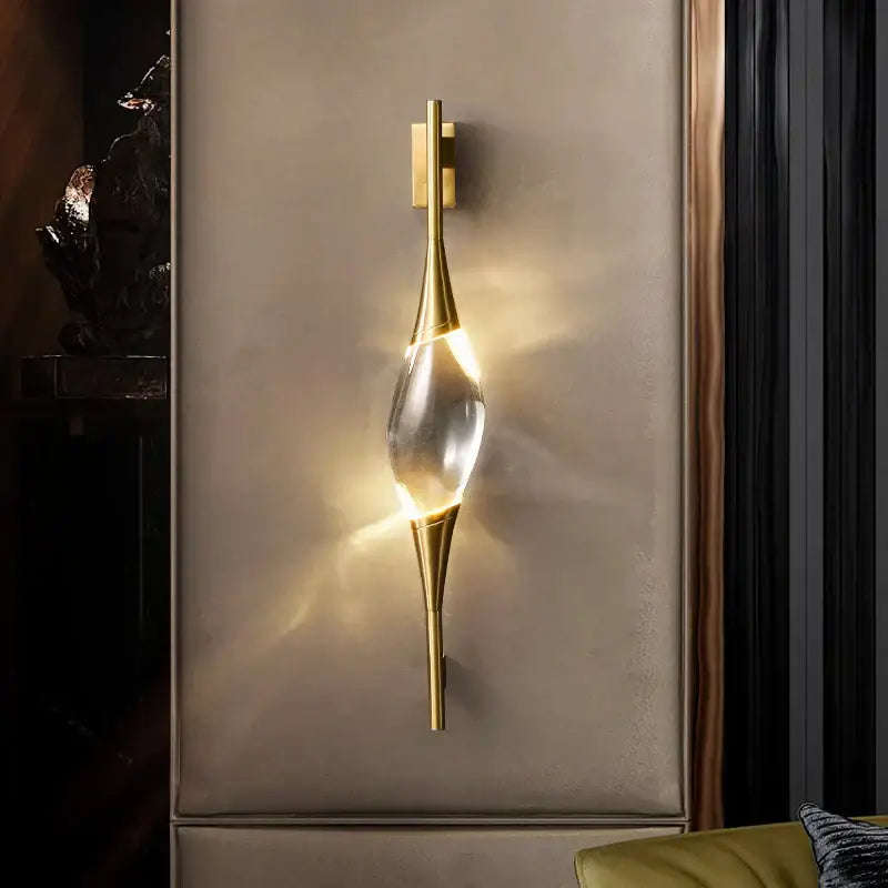 Modern gold crystal wall sconce with a clear teardrop-shaped centerpiece ideal for bedroom decorbites crystal wall lighting