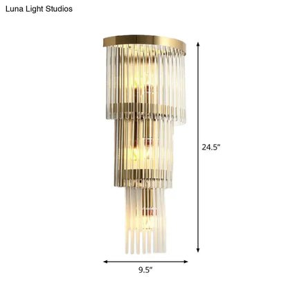 Modern gold crystal wall sconce with gold metal frames and clear glass rods emitting warm glow for living space 110v-120v