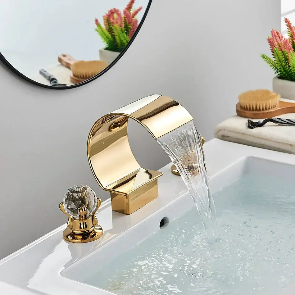 Modern gold crystal waterfall basin faucet with a sleek curved design and crystal knob for bathroom sink decorbites crystal waterfall