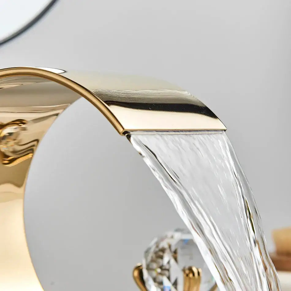 Modern gold decorbites crystal waterfall basin faucet with sleek curved design and crystal accents for bathroom sink