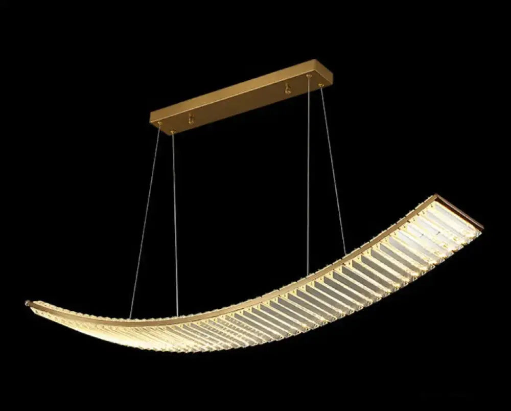Modern gold-toned suspended crystal chandelier with curved ribbed crystal design for dining room lighting