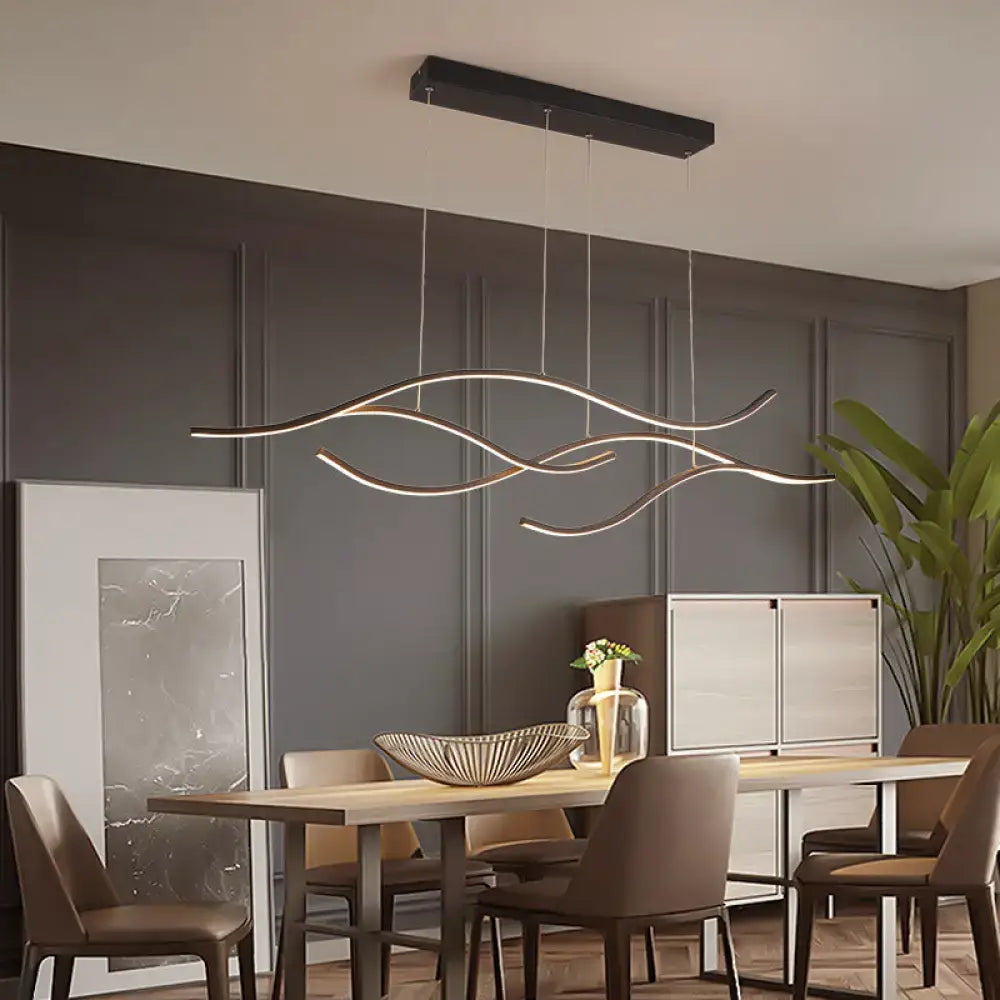 Modern black and gold curved metal pendant light with sleek flowing design kitchen lighting fixture