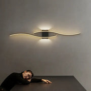 Modern gold curved led wall lamp with sleek design and warm ambient lighting for bedroom use