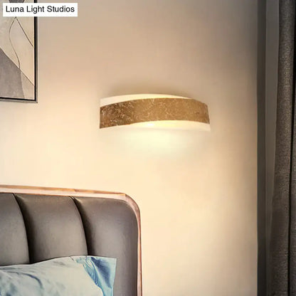Modern gold curved led wall lamp with a metallic band and white diffuser for stylish living room wall mount lighting
