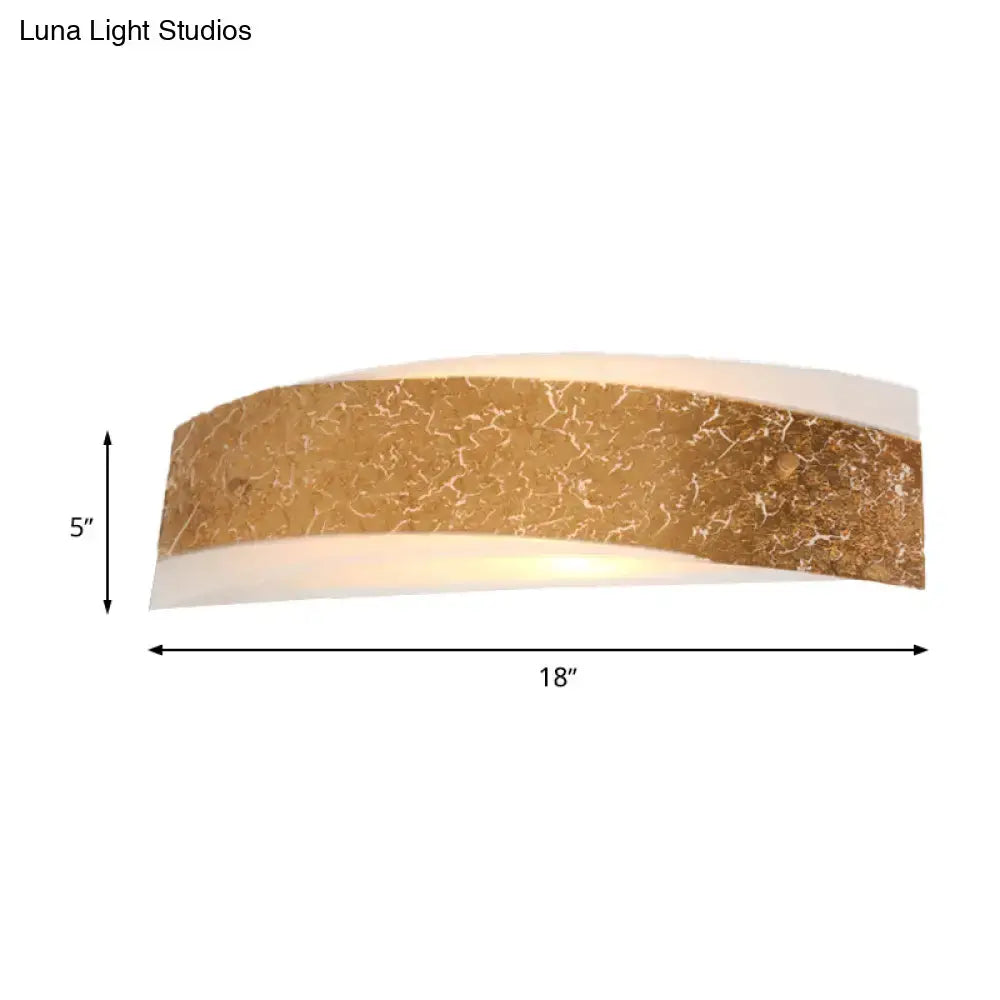 A sleek modern gold curved wall lamp with marble-patterned top and smooth white underside for wall mount lighting
