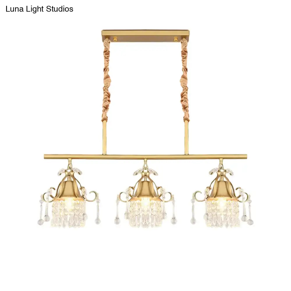 Gold-toned DecorBites™ island pendant light with three crystal teardrop heads and twisted rope gold cylinder cords