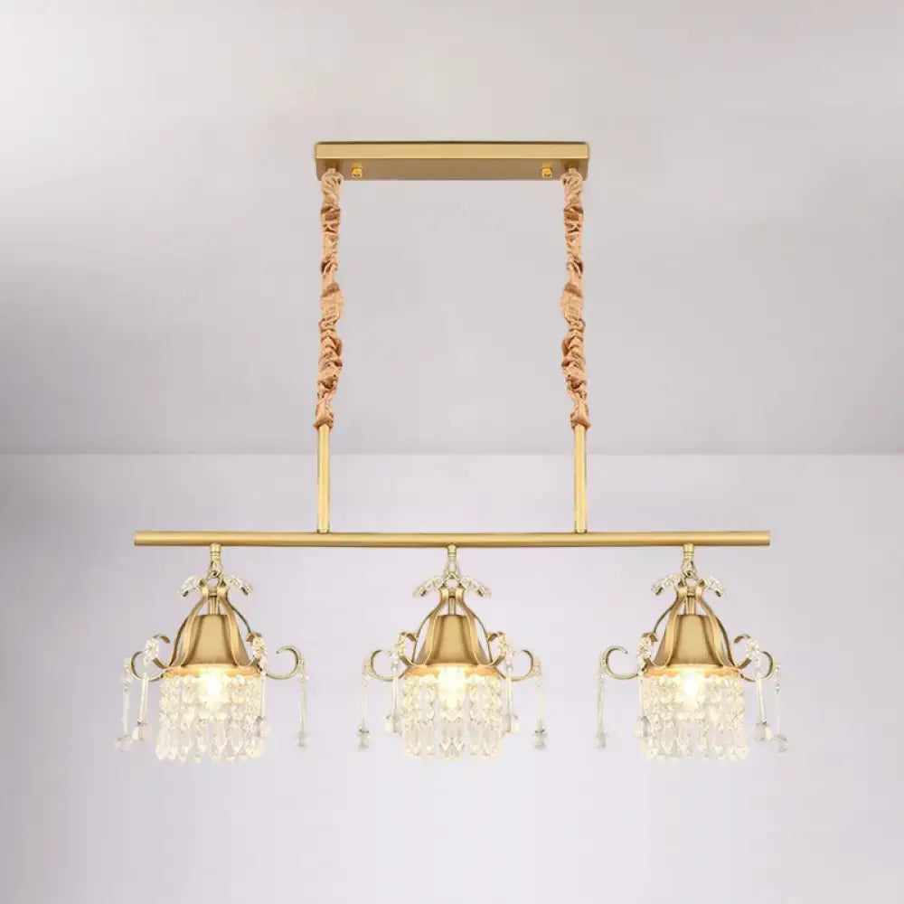 Gold-toned DecorBites™ crystal teardrop island pendant light with gold cylinder and three ornate crystal pendant heads