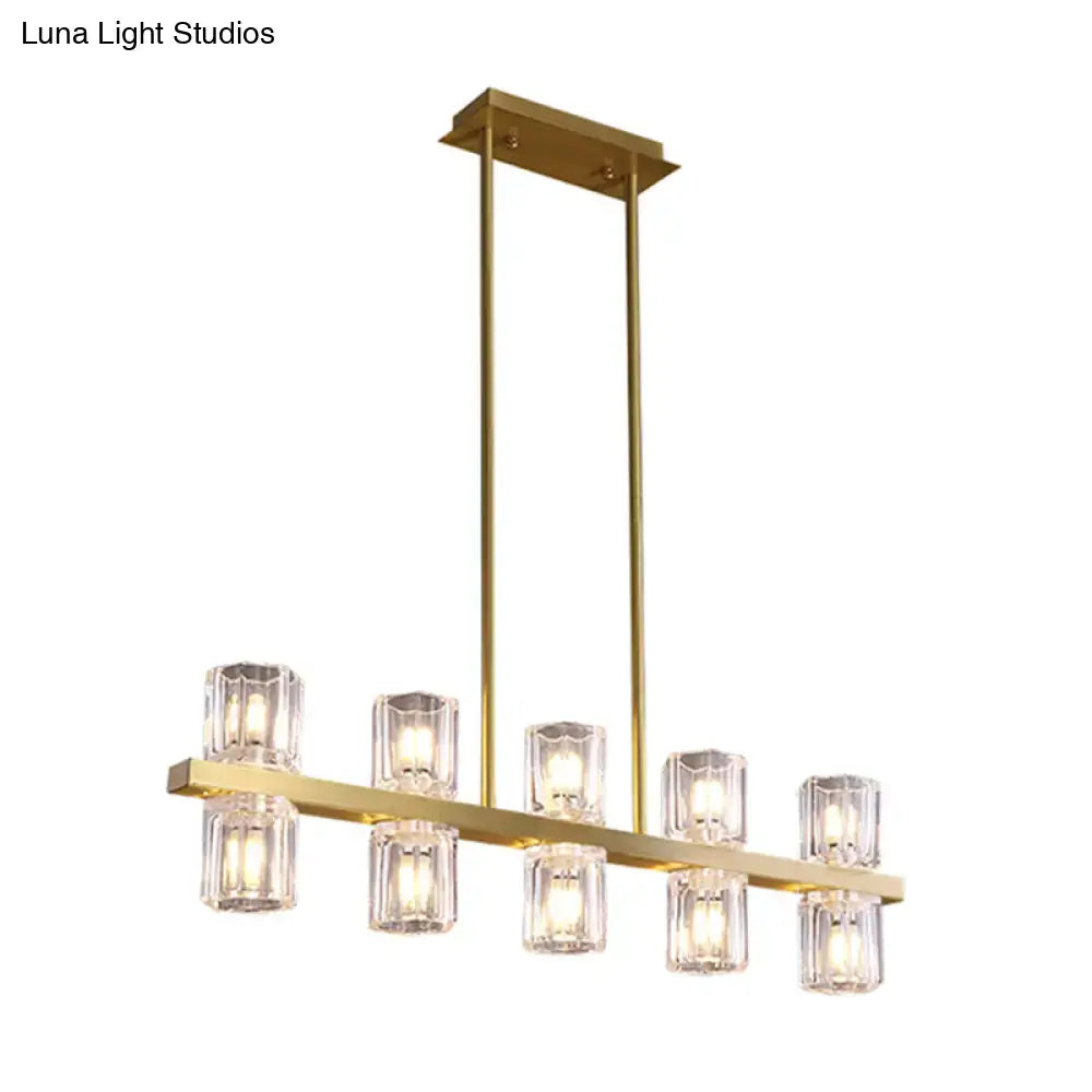 Modern gold cylinder island light chandelier with six faceted crystal glass shades in a linear design for dining room