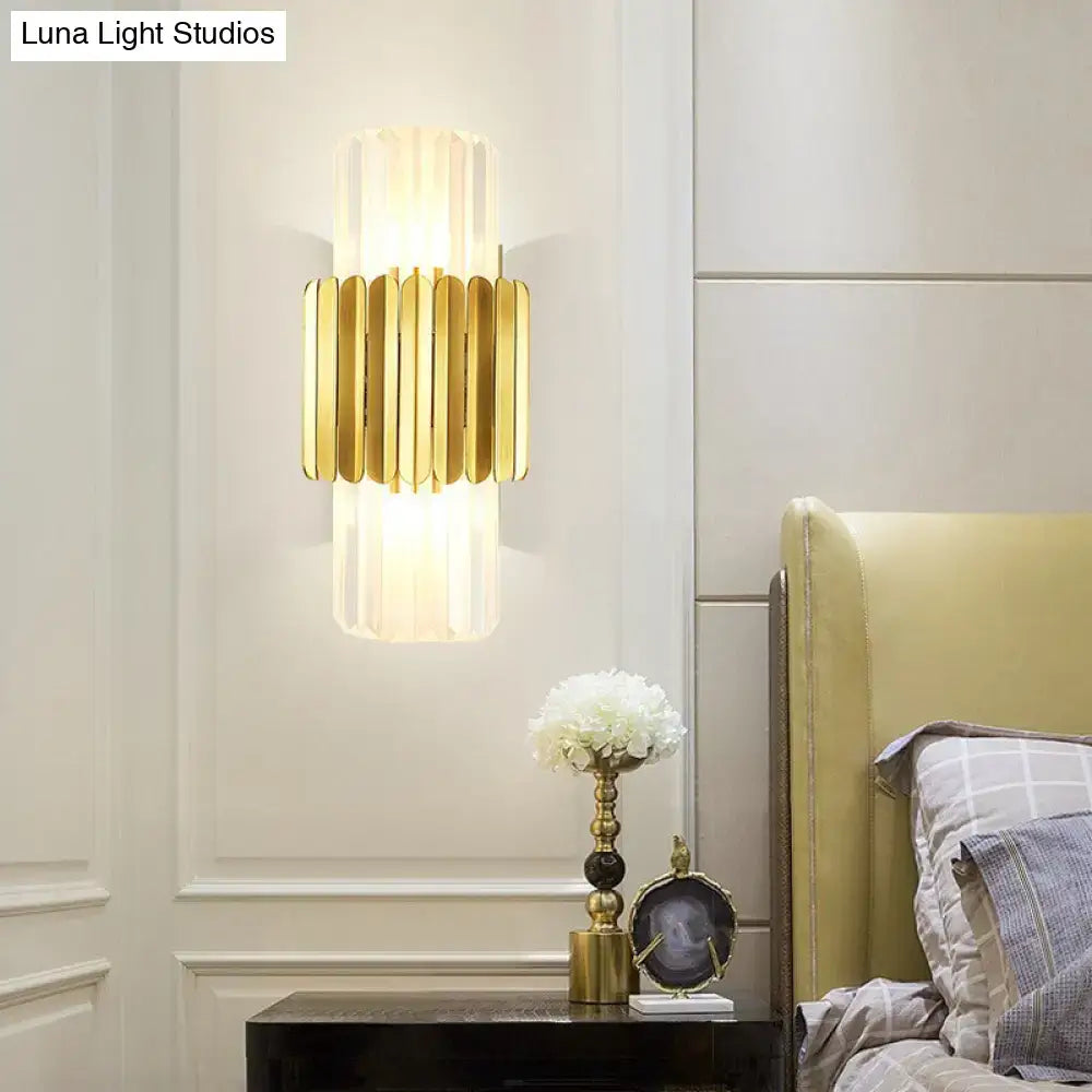Modern gold cylinder wall mount lamp with vertical ribbed glass panels and sleek metallic frame for bedroom use