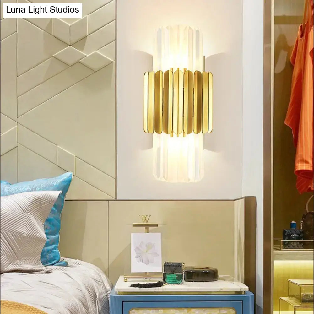 Modern gold cylinder wall mount lamp with vertical bars and translucent glass diffuser for bedroom use