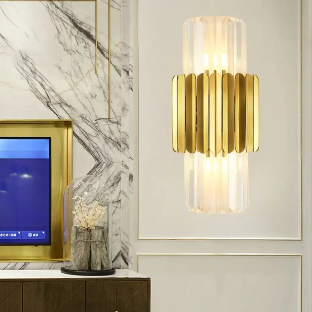 Modern gold cylinder wall mount lamp with vertical crystal panels and sleek design for bedroom lighting