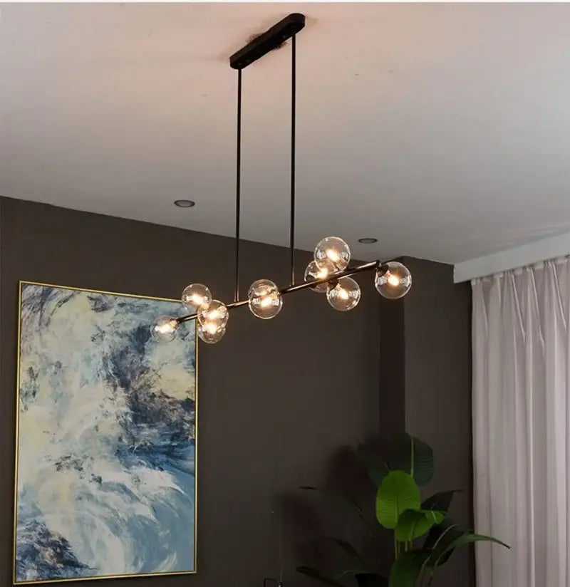 Modern black metal chandelier with clear glass globe bulbs for dining room featuring decorbites bubble ball led design