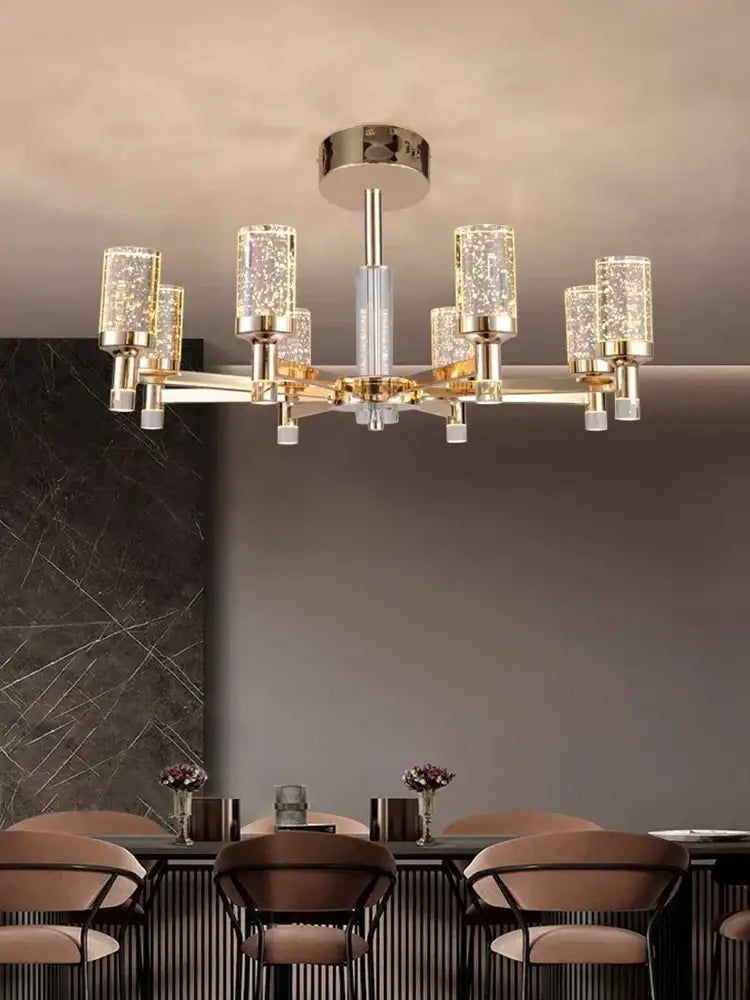 Modern gold decorbites bubble crystal chandelier with gold-toned metal arms and cylindrical crystal shades for living room