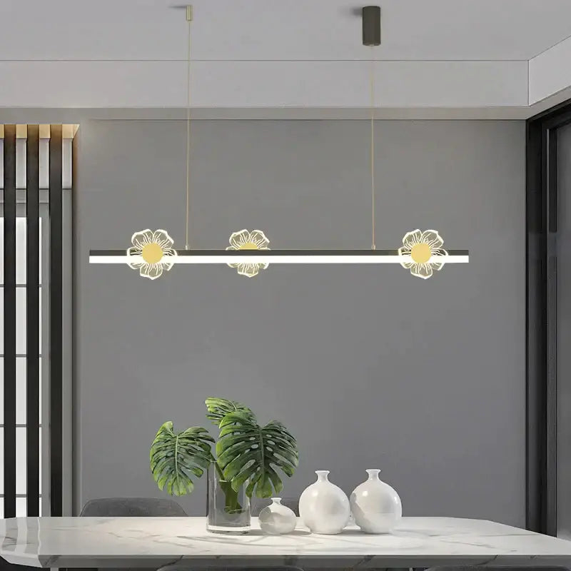 Modern gold decorbites butterfly flower chandelier featuring three illuminated white and gold floral pendants for dining room lighting