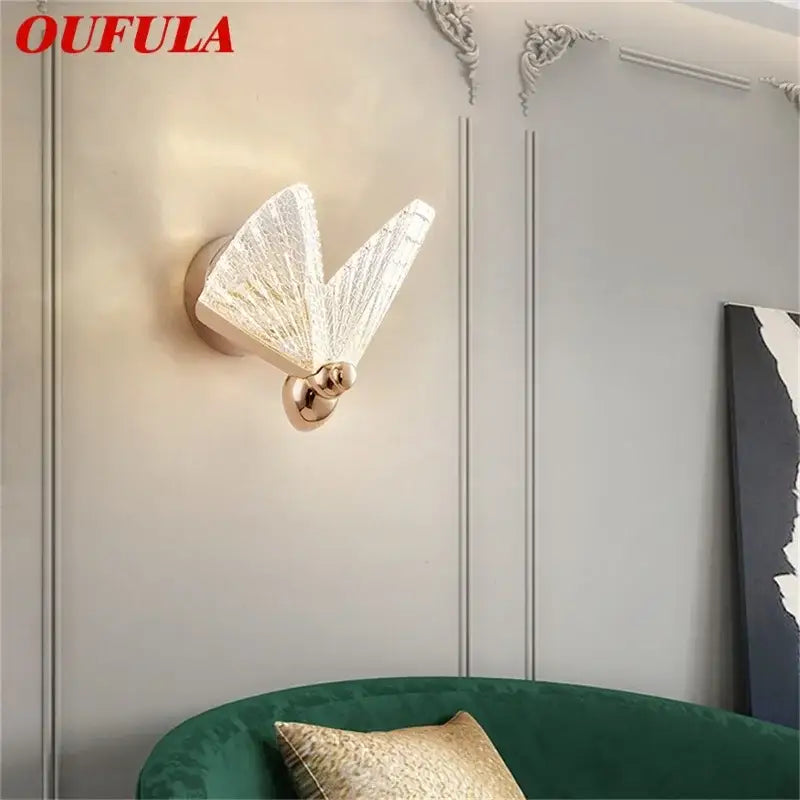 Oufula decorbites butterfly wall sconce with translucent textured glass wings and polished gold metal base for bedroom lighting