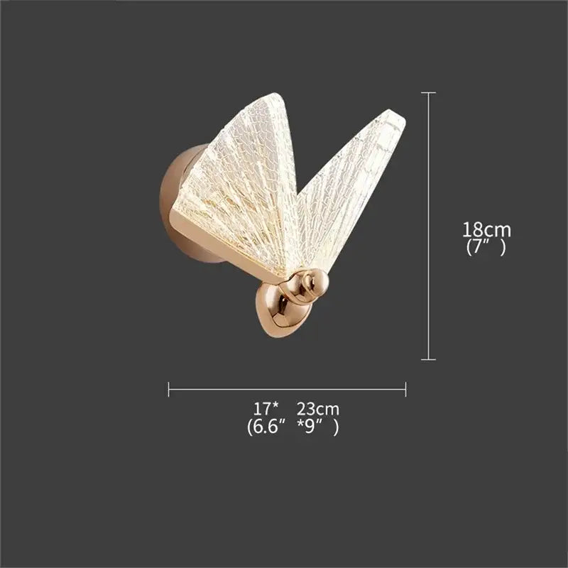 Modern gold decorbites butterfly wall light with translucent textured glass wings and sleek metallic base for bedroom