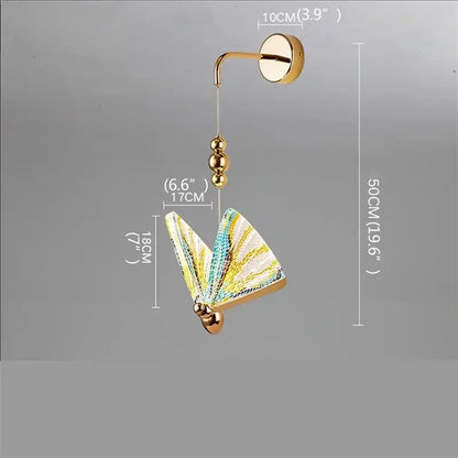 Modern gold decorbites butterfly wall sconce with iridescent yellow teal and white glass wings for bedroom lighting