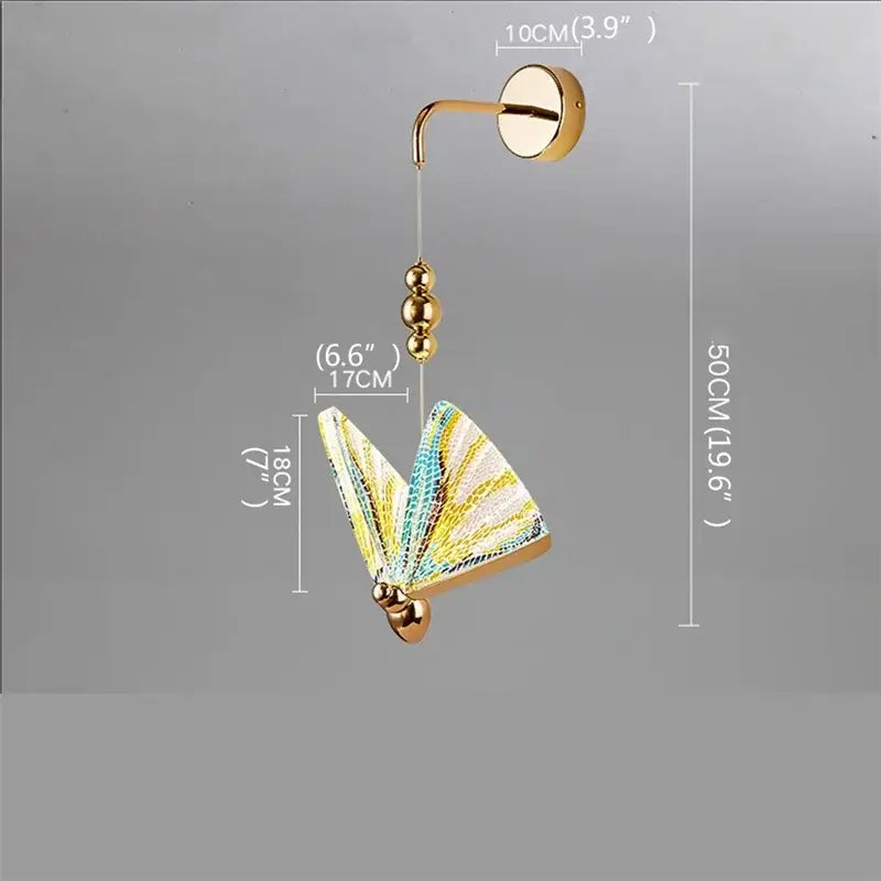 Modern gold decorbites butterfly wall sconce with iridescent yellow teal and white glass wings for bedroom lighting