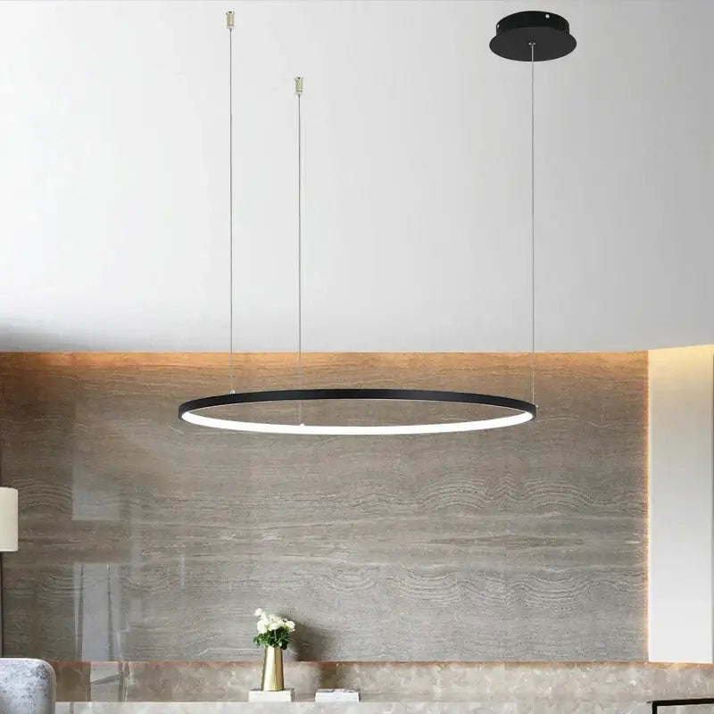 Black decorbites circular led chandelier with sleek modern design and thin metallic suspension cords for dining room lighting