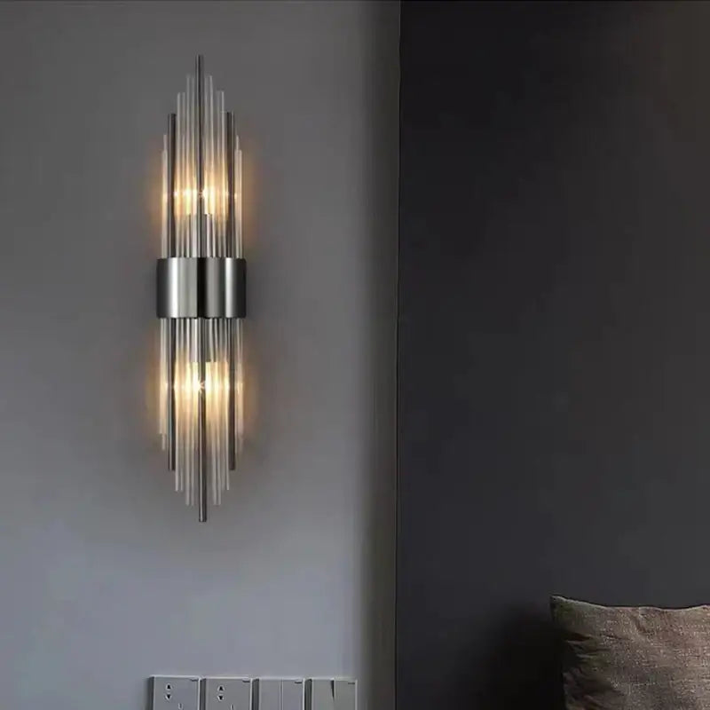 Modern gold decorbites clear crystal led wall lamp with sleek metallic finish and vertical glass rods emitting warm light