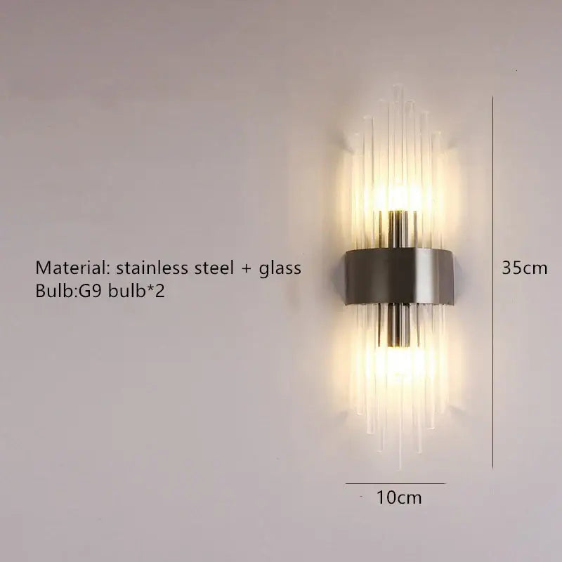 Modern gold decorbites clear crystal led wall lamp with sleek stainless steel frame and warm vertical glass rods bedroom sconce