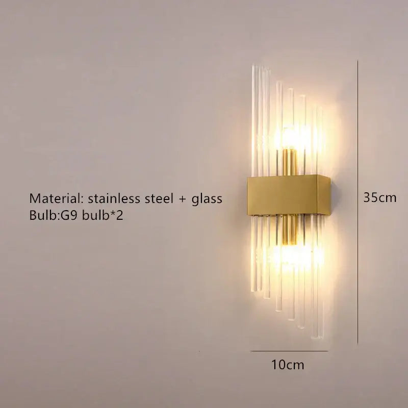Modern gold decorbites clear crystal led wall lamp with rectangular stainless steel base and vertical glass rods bedroom sconce