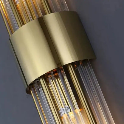 Modern gold decorbites clear crystal led wall lamp with gold-toned metallic base and clear glass tubes bedroom sconce
