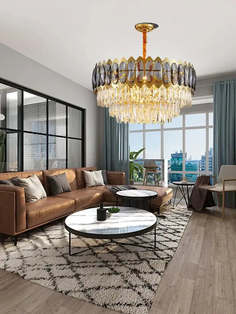 A modern gold decorbites crystal ceiling chandelier with cascading crystal droplets and dark faceted glass frame