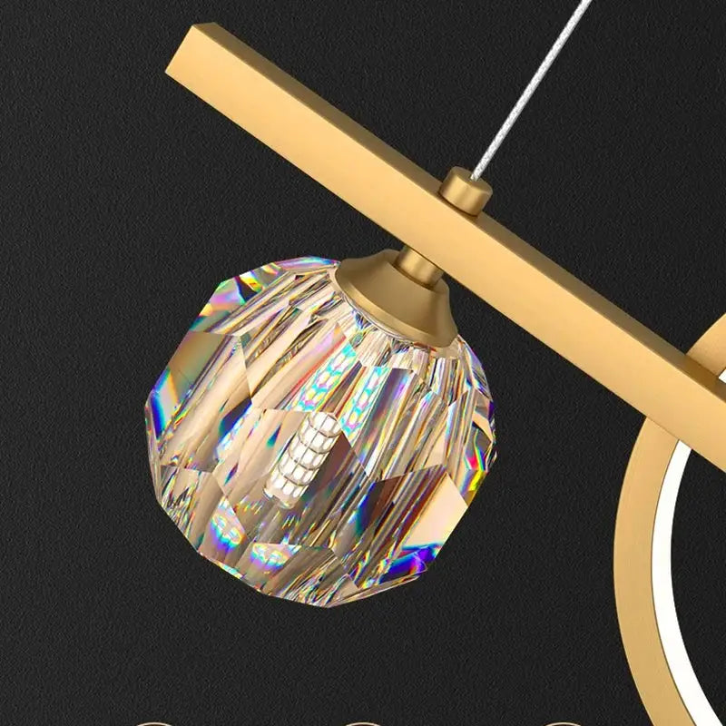 A faceted crystal globe pendant light with gold-toned metal frame for modern gold decorbites crystal chandelier