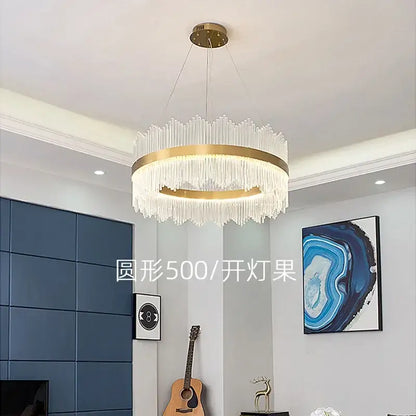 A modern gold decorbites crystal chandelier with a circular metal frame and cascading clear crystal prisms for living room