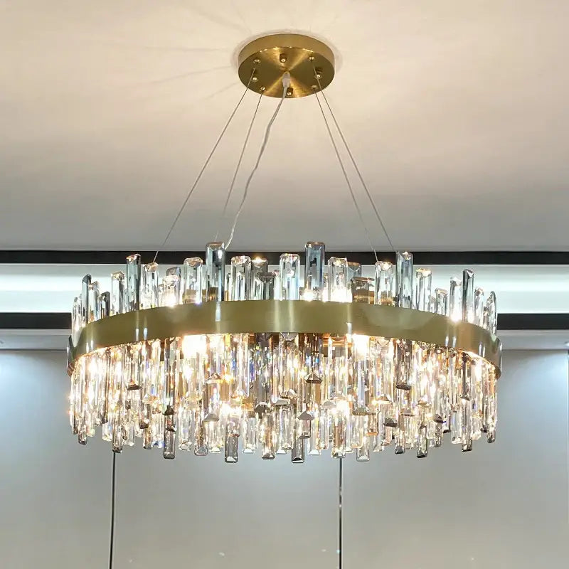 Modern gold decorbites crystal chandelier with circular metal frame and cascading clear prisms for living room use