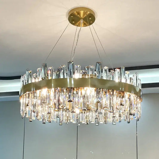 Modern gold decorbites crystal chandelier with circular metal frame and cascading clear crystal prisms for living room