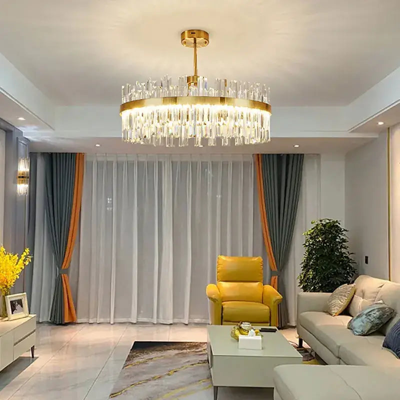 Modern gold decorbites crystal chandelier featuring cascading clear crystal prisms for living and dining rooms