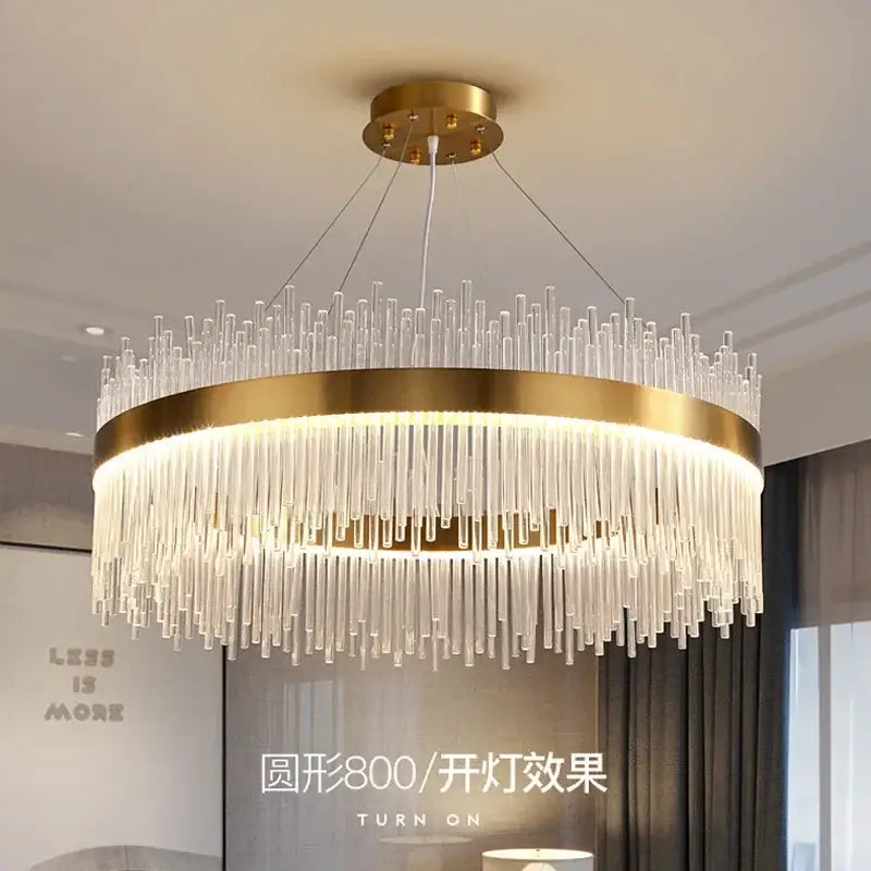 Modern gold decorbites crystal chandelier featuring cascading clear glass rods and a glowing inner ring for living room
