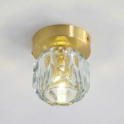 A clear faceted crystal globe with a gold metal base in a modern gold decorbites crystal led ceiling light
