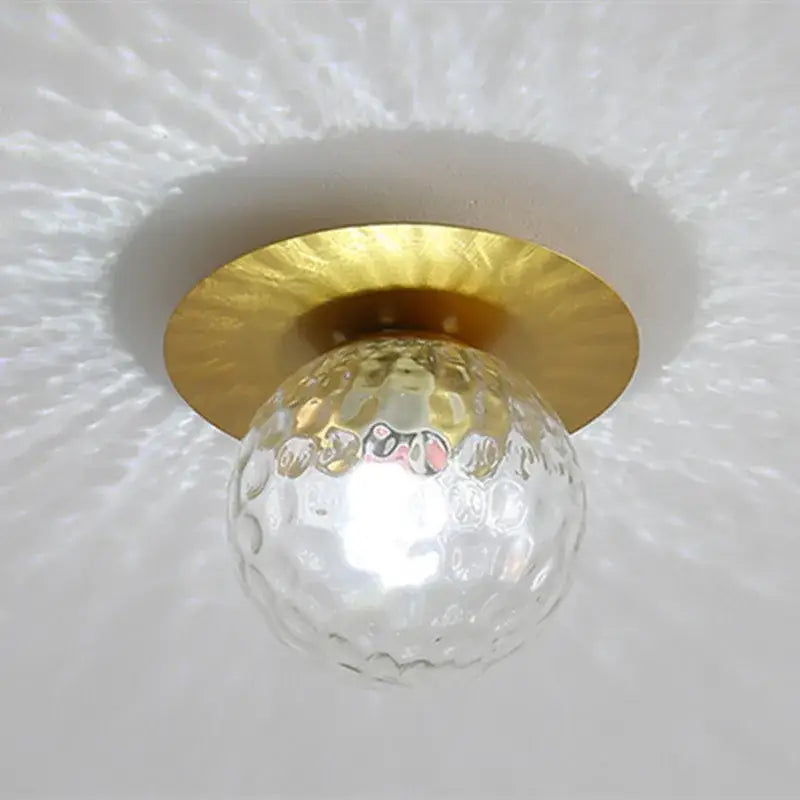 Clear textured glass globe with gold-toned metal base in modern gold decorbites crystal led ceiling light for living room