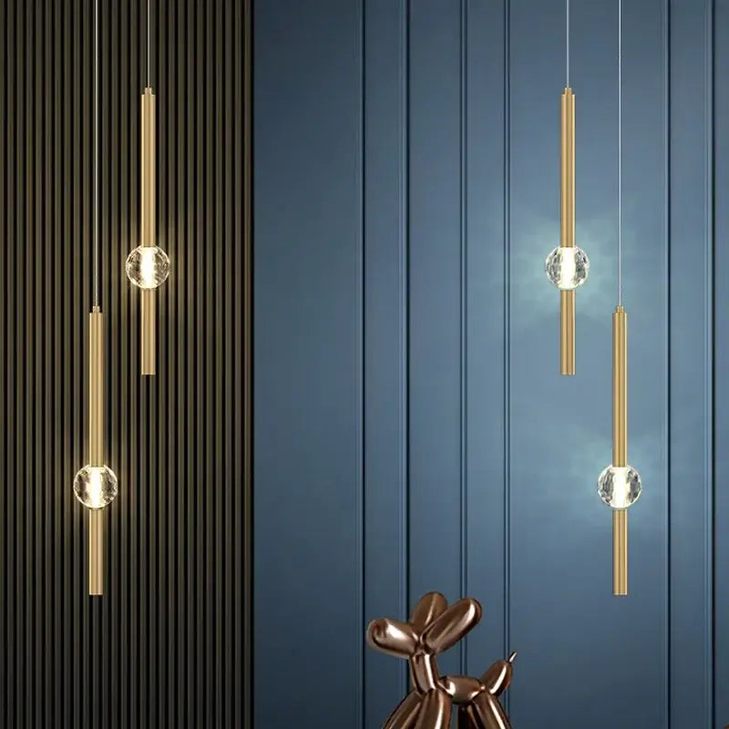 Modern gold decorbites crystal led pendant light featuring gold-toned cylinders and clear crystal spheres suspended by cords
