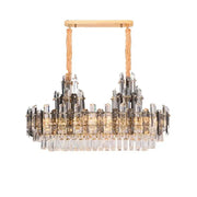 A modern gold decorbites crystal led chandelier with textured cords and cascading clear smoky crystal prisms