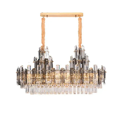A modern gold decorbites crystal led chandelier with textured cords and cascading clear smoky crystal prisms