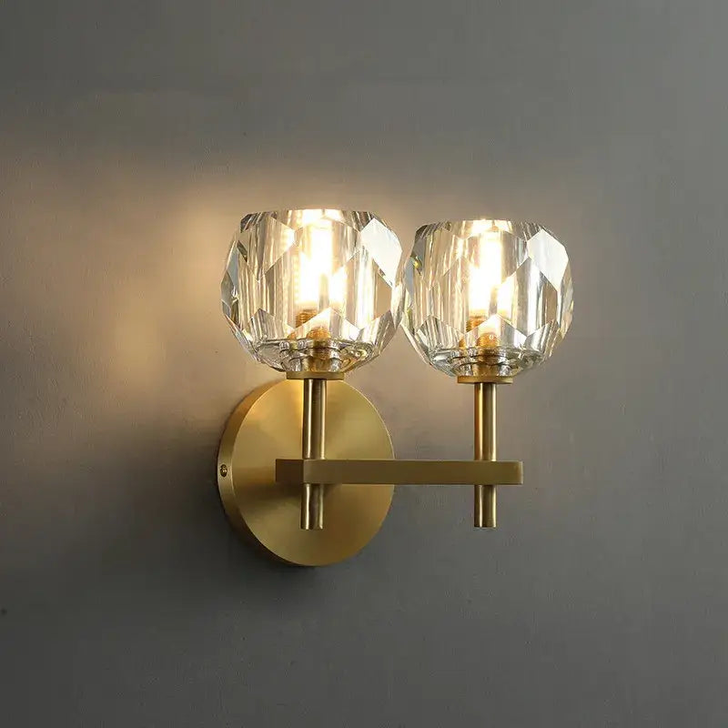 Brass-finished wall sconce with two faceted crystal glass shades from decorbites crystal led chandelier collection