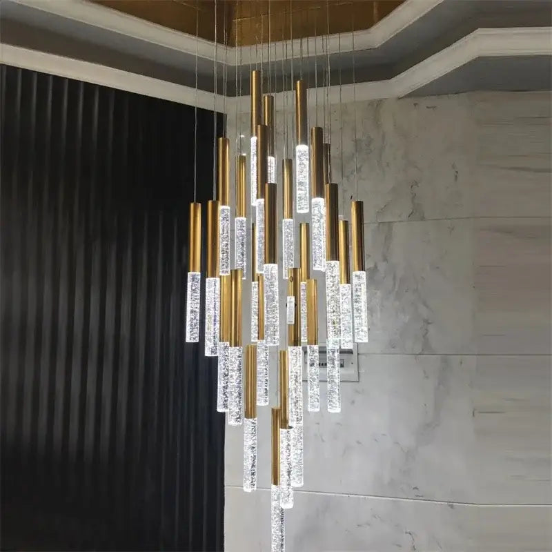 A modern gold decorbites crystal led chandelier with cylindrical rods and cascading clear crystal segments for living rooms