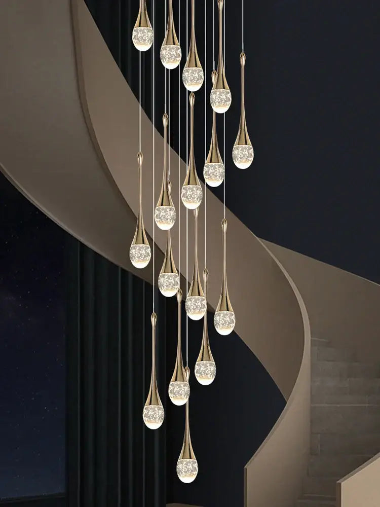 Modern gold decorbites crystal led chandelier with teardrop pendant lights and clear crystal globes for staircase lighting