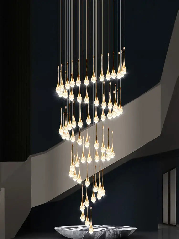 Modern gold decorbites crystal led chandelier with golden teardrop shape and cascading crystal accents for staircase lighting